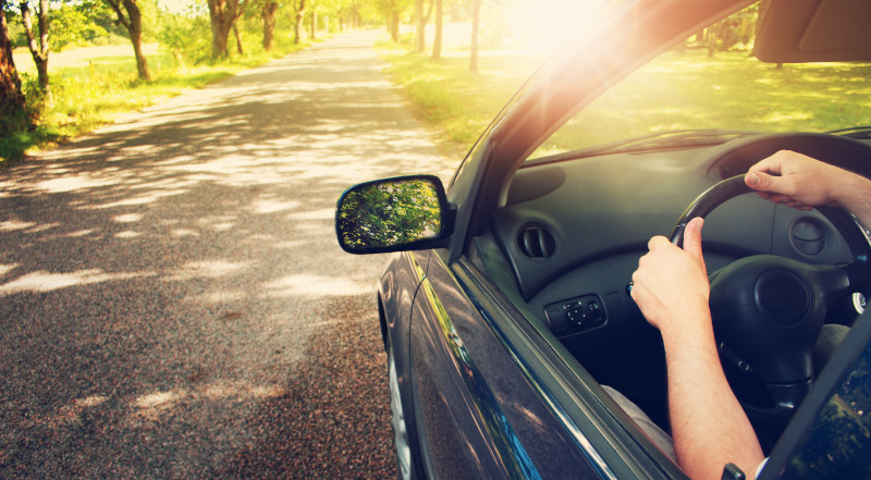 Partial view of a car on a country road