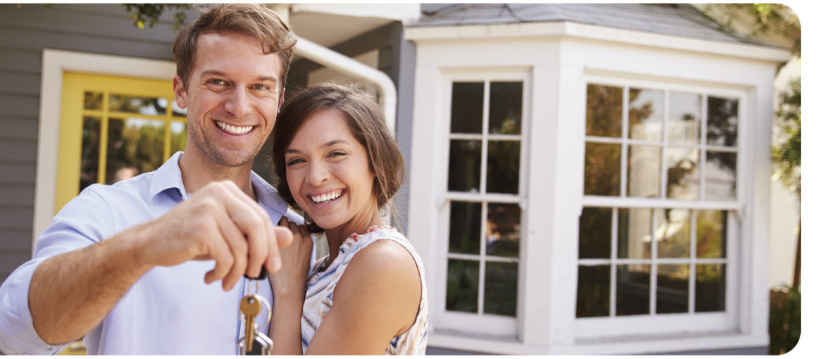 A happy couple with keys to their home